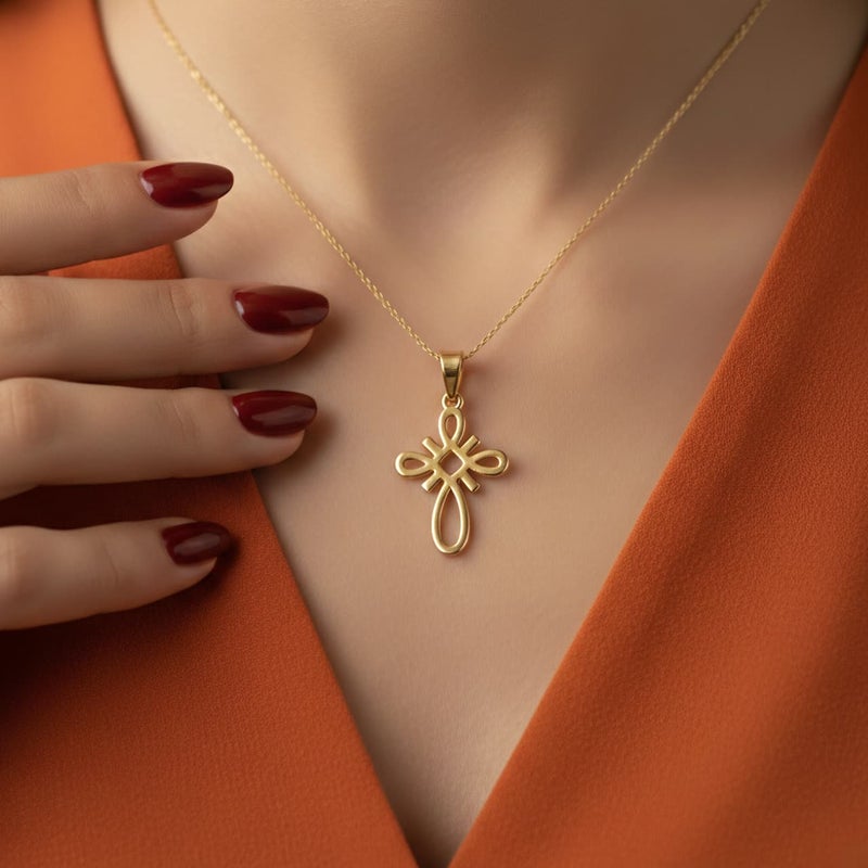 A small gold-tone cross pendant (chain not included), crafted from rust-resistant stainless steel, featuring a sleek, openwork knot design. A distinctive, modern, and spiritual piece. - Image 5